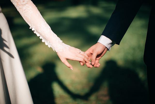 A bride and groom holding hands.