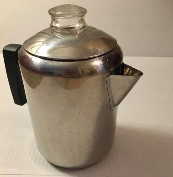 Old, slightly discolored coffee percolator.