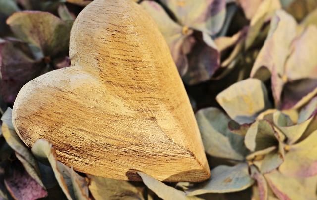 wooden heart on bed of dried flowers